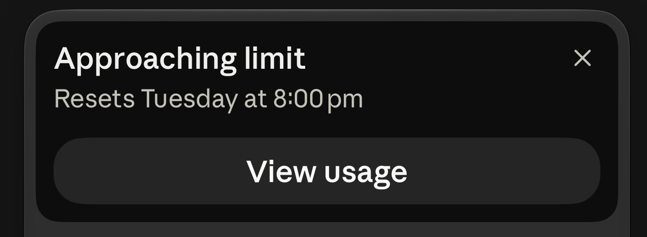 Claude Code's notice: Approaching limit. Resets Tuesday at 8:00 pm. A View usage button below.